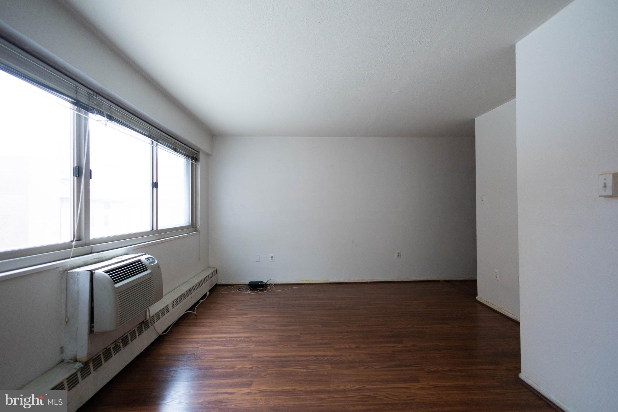 a view of an empty room and wooden floor