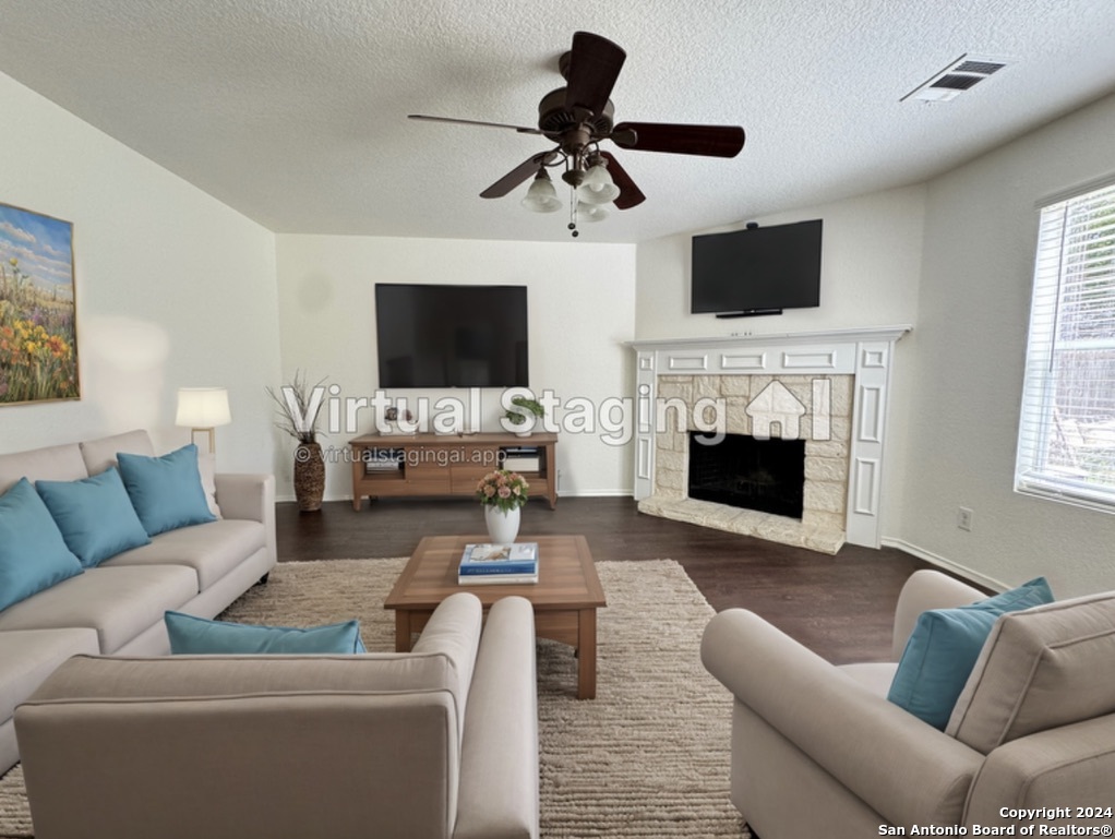 a living room with furniture a fireplace and a flat screen tv