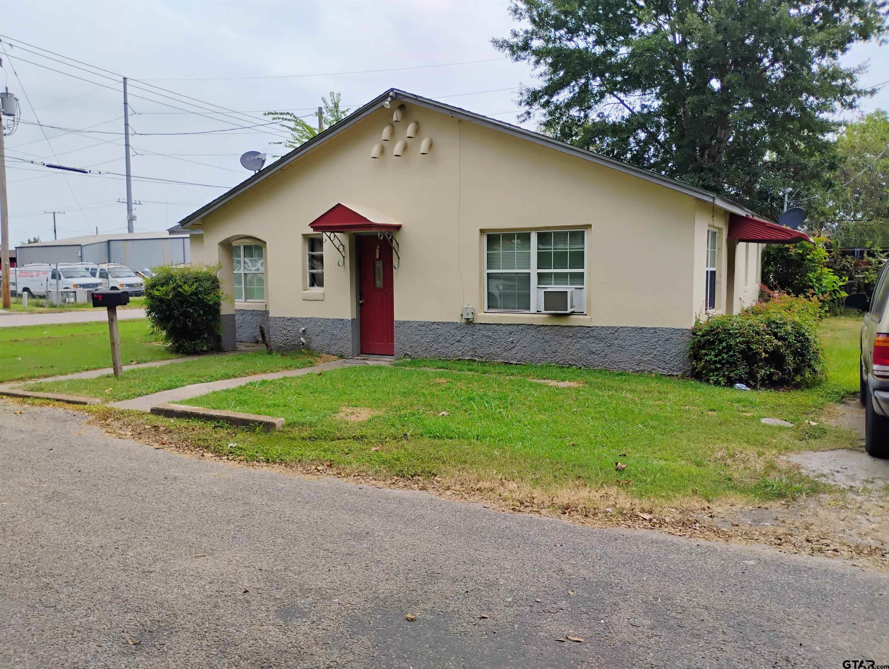 a view of a house with a yard and a garage