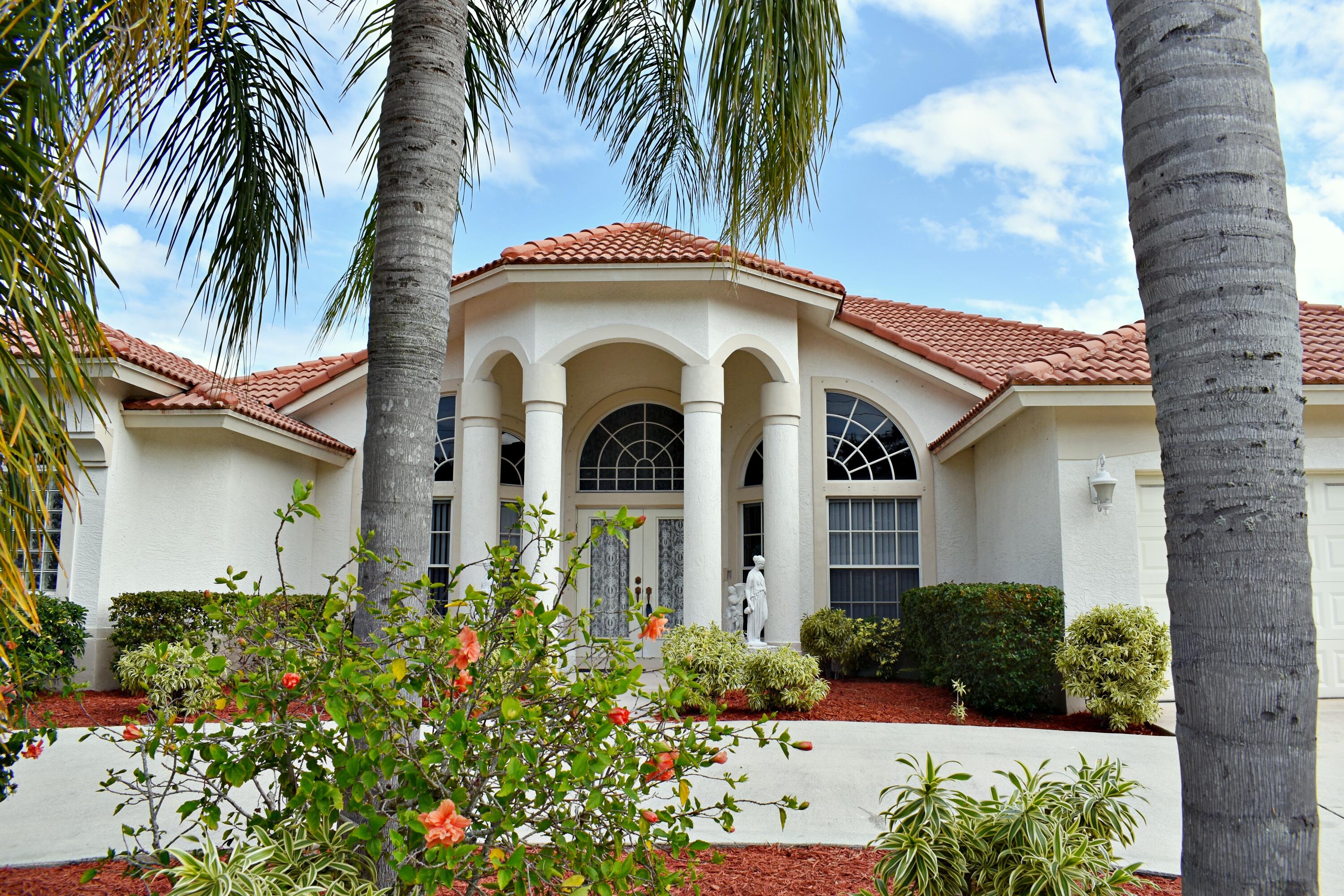 a front view of a house with a garden