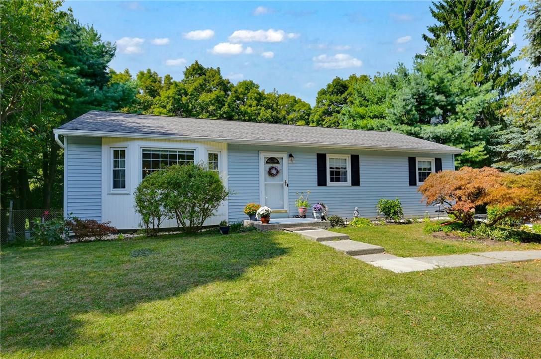 Single story home with a front yard