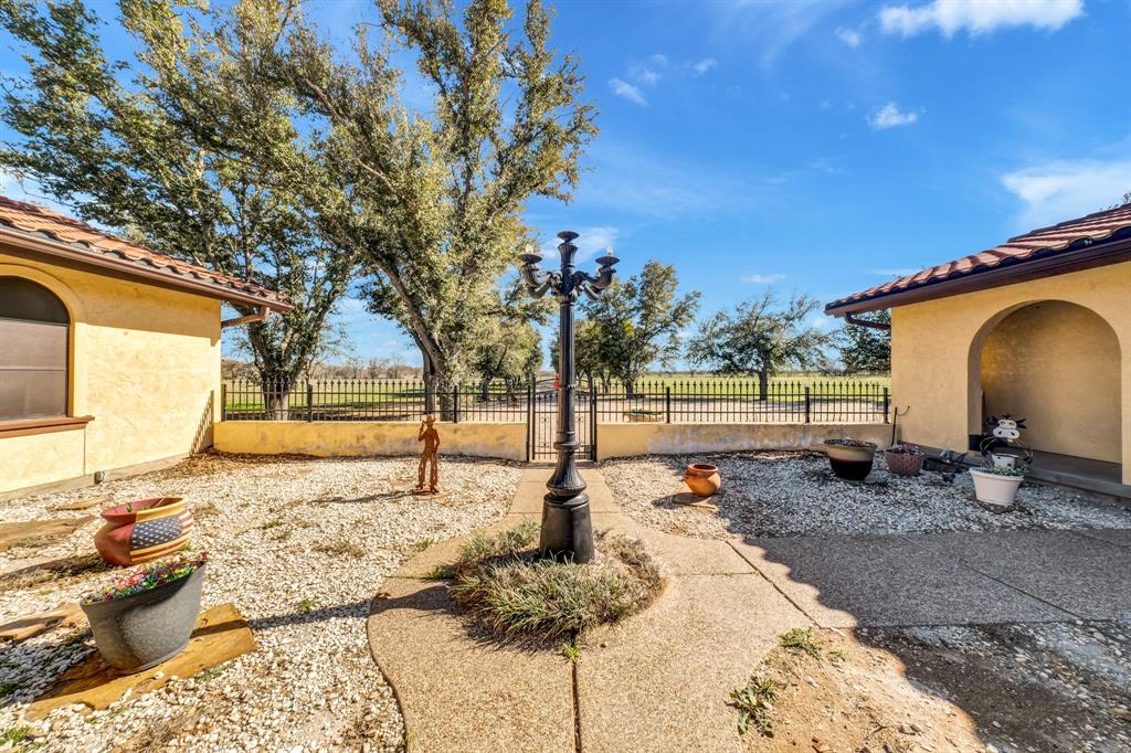 a backyard of a house with table and chairs