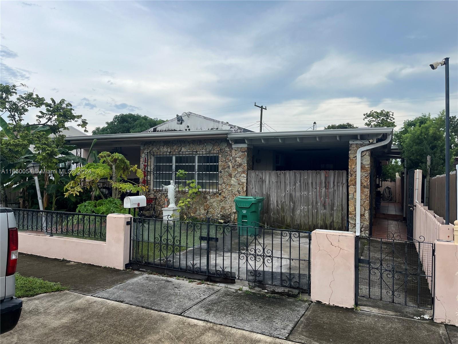 a front view of house with a garden