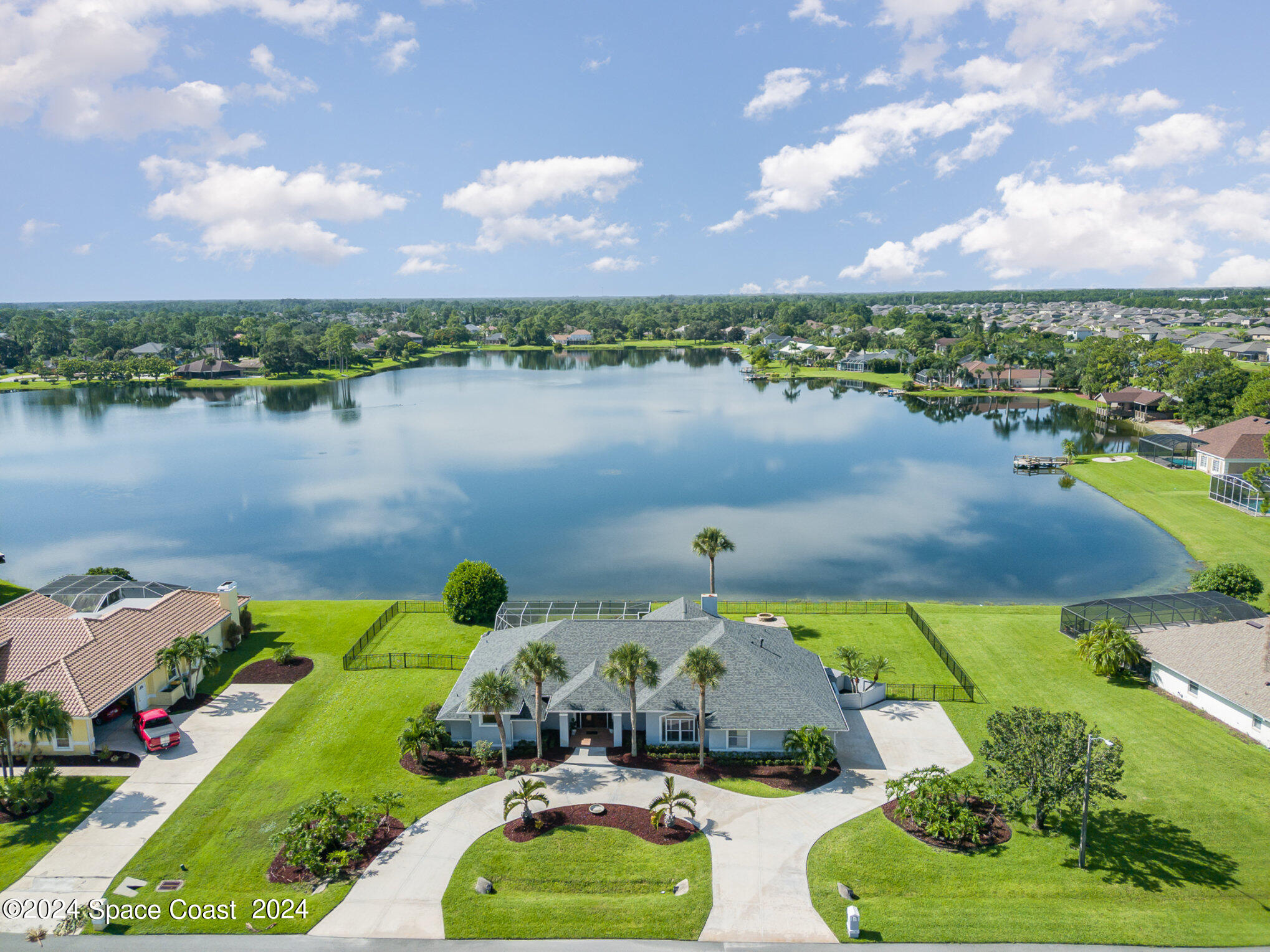 an aerial view of a house with a lake view