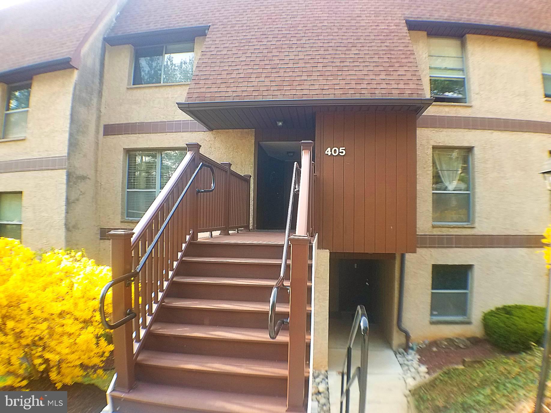 a view of entryway with wooden floor and a front door