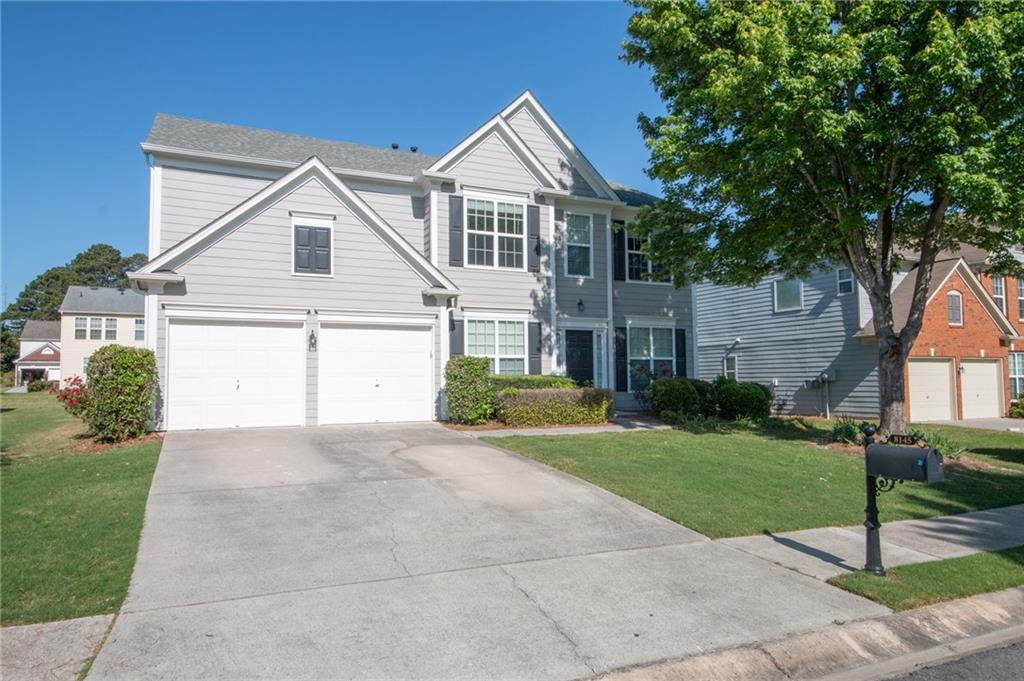 a front view of a house with a yard and garage