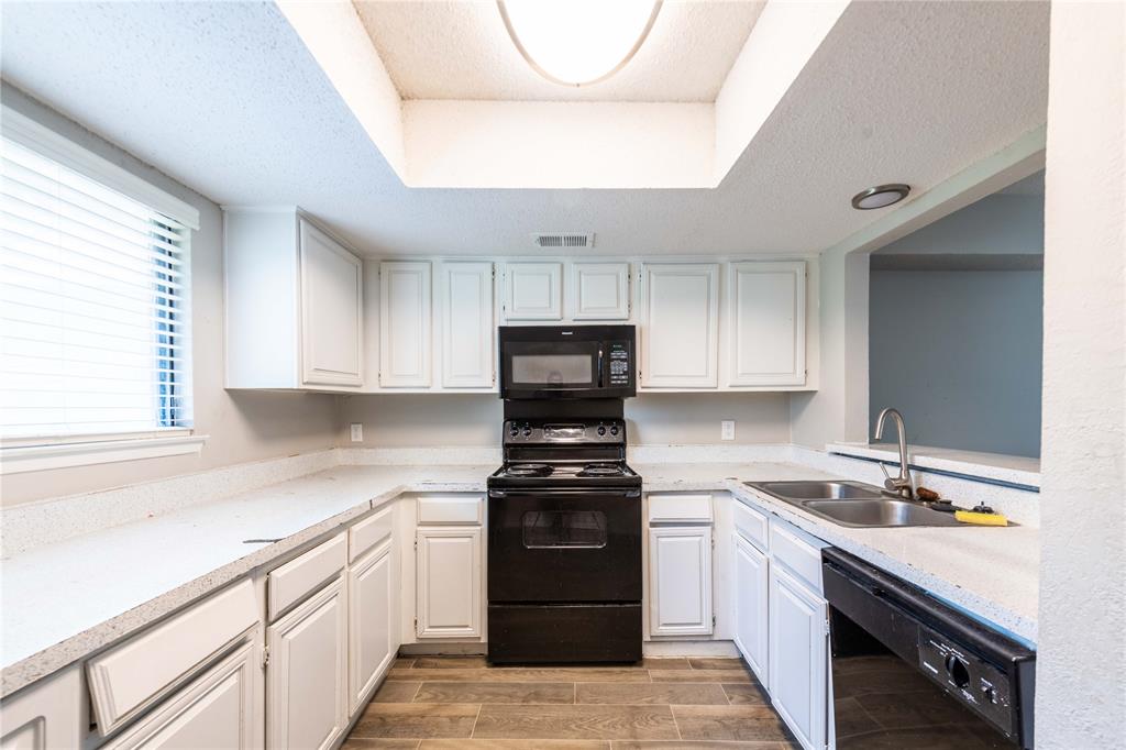 a kitchen with a sink and a stove