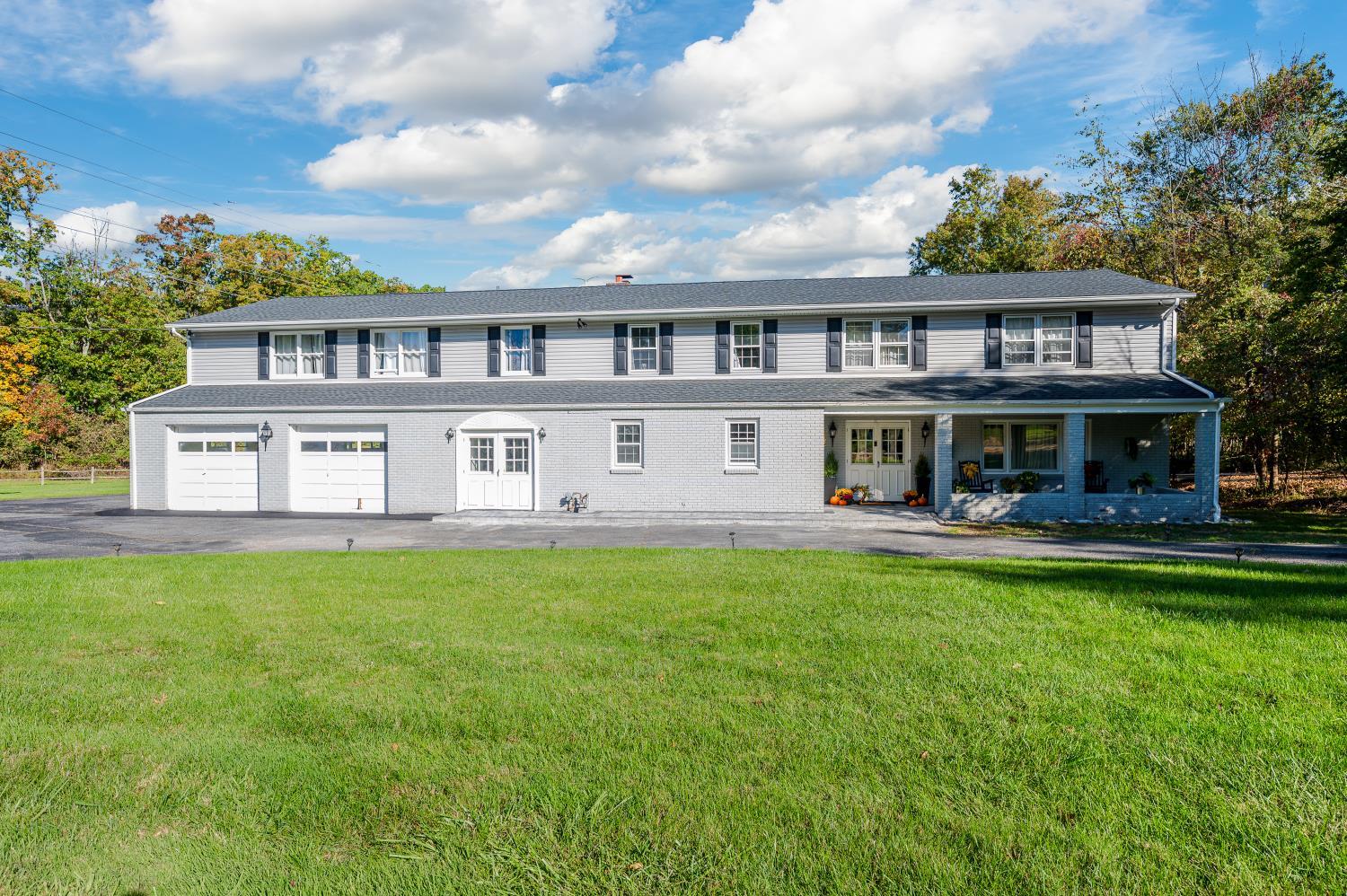 View of front of home featuring a front yard and a garage