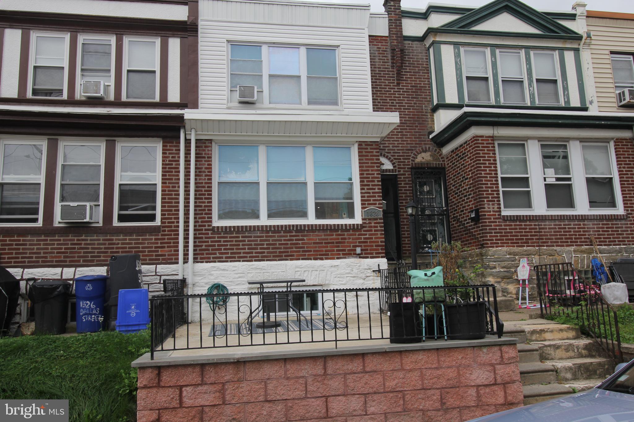 a view of a brick house with many windows