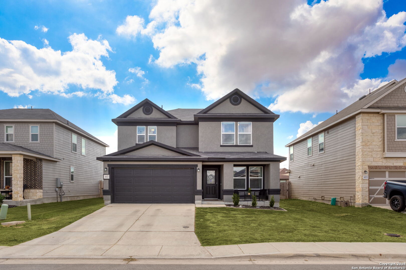 a front view of a house with a yard