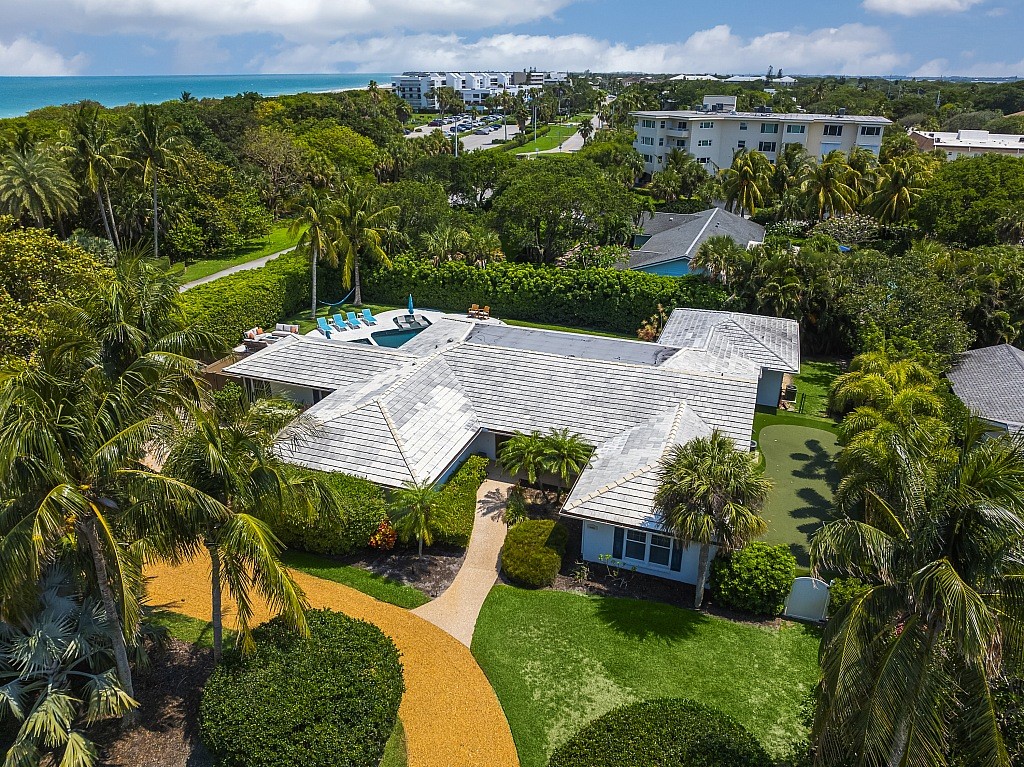 an aerial view of a house with yard