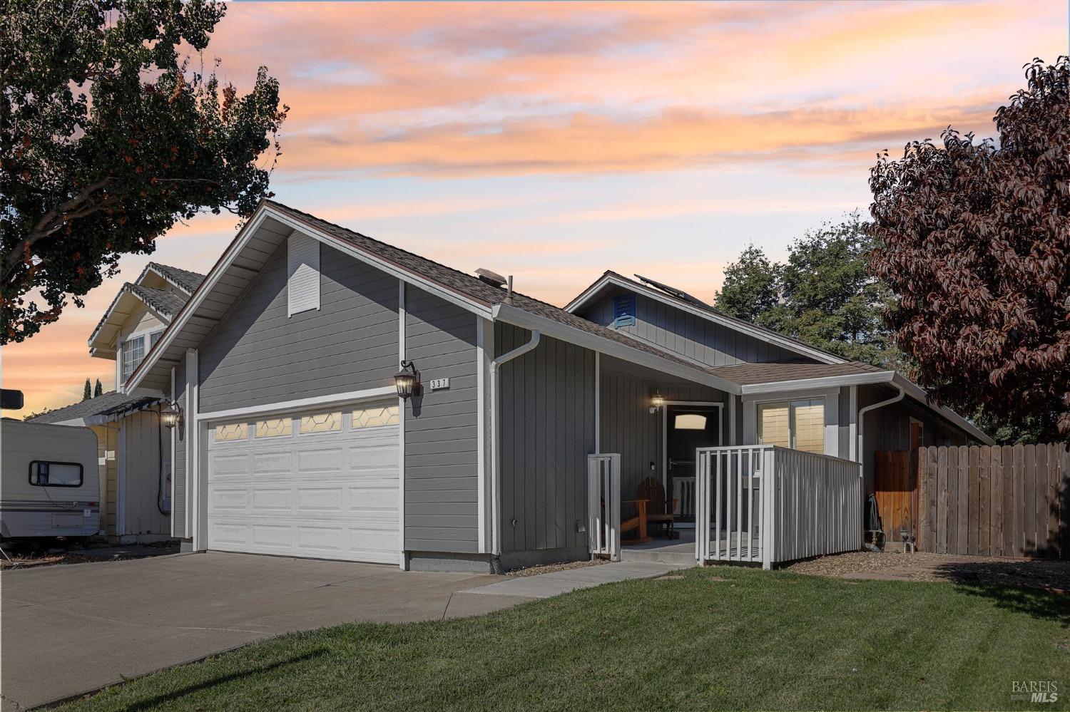 a view of house with backyard and trees