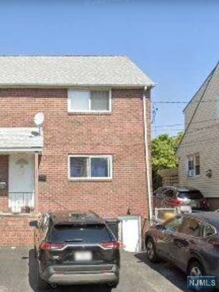 a front view of a house with parking space