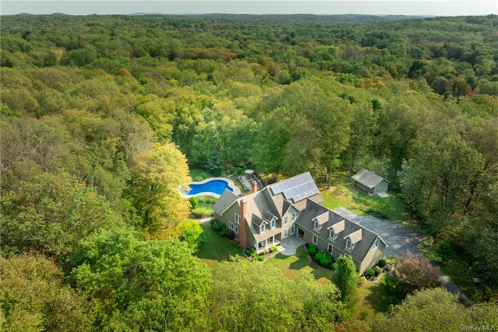 an aerial view of a house with a yard