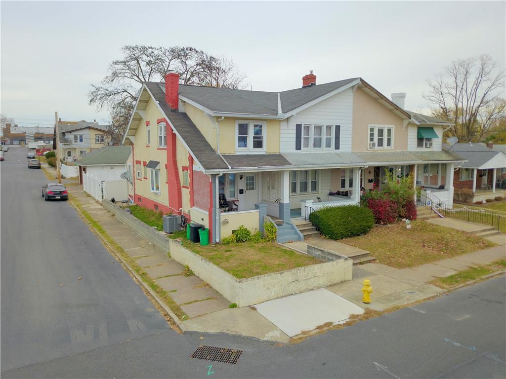 a view of a white building among the street and houses