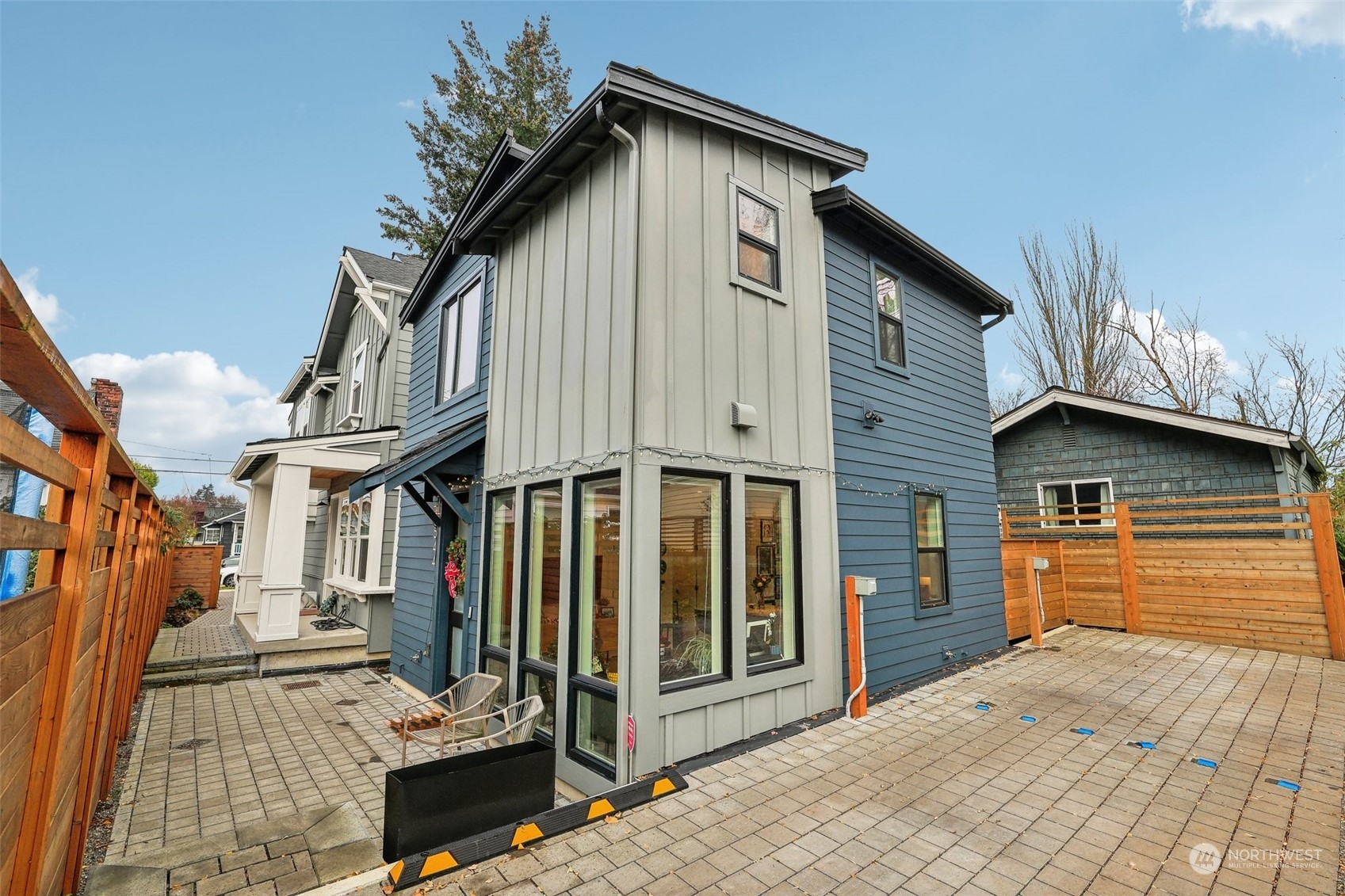 a view of a house with wooden fence