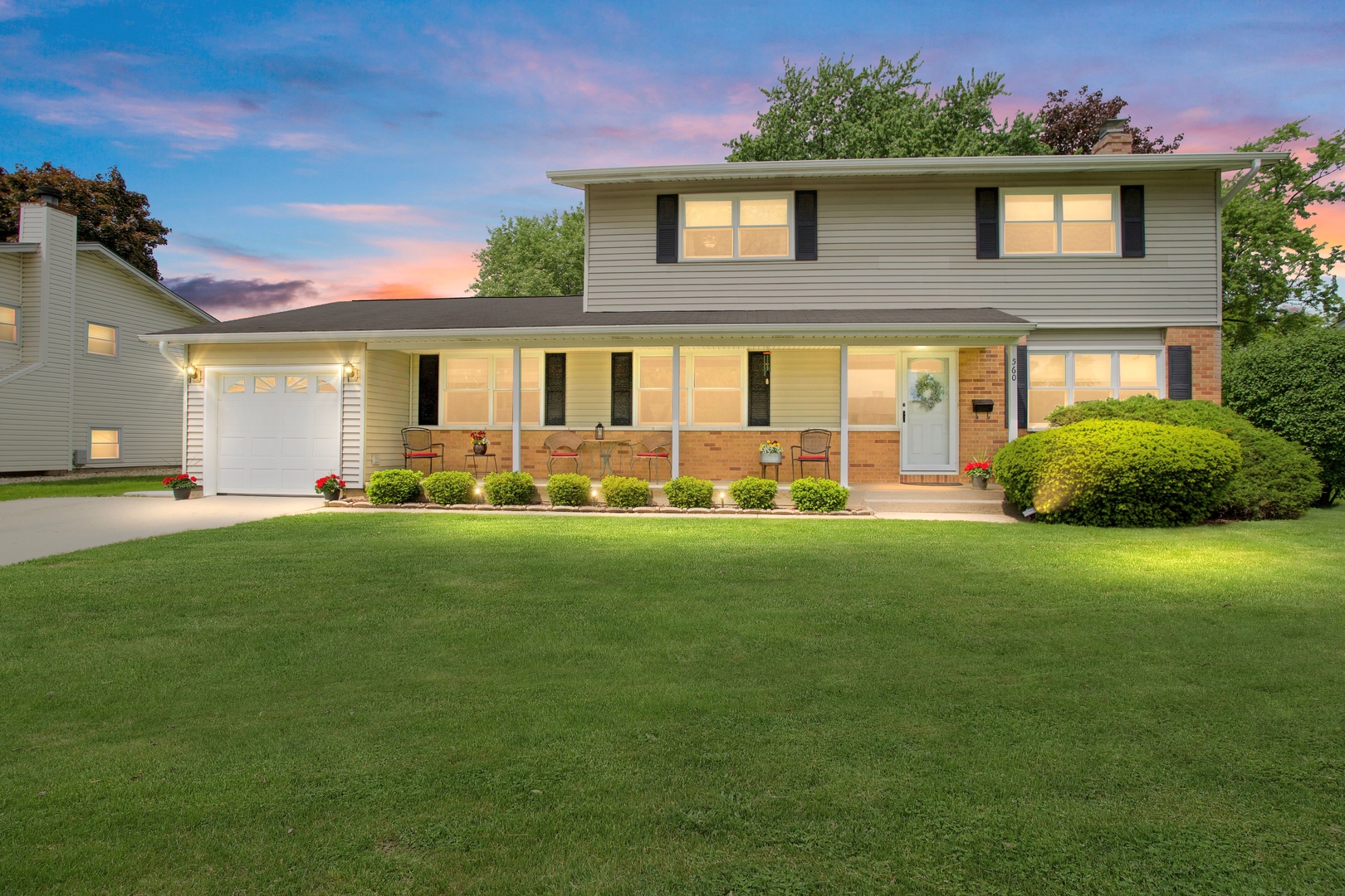 a front view of house with yard and green space