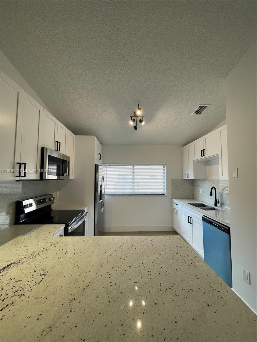 a large kitchen with a large window