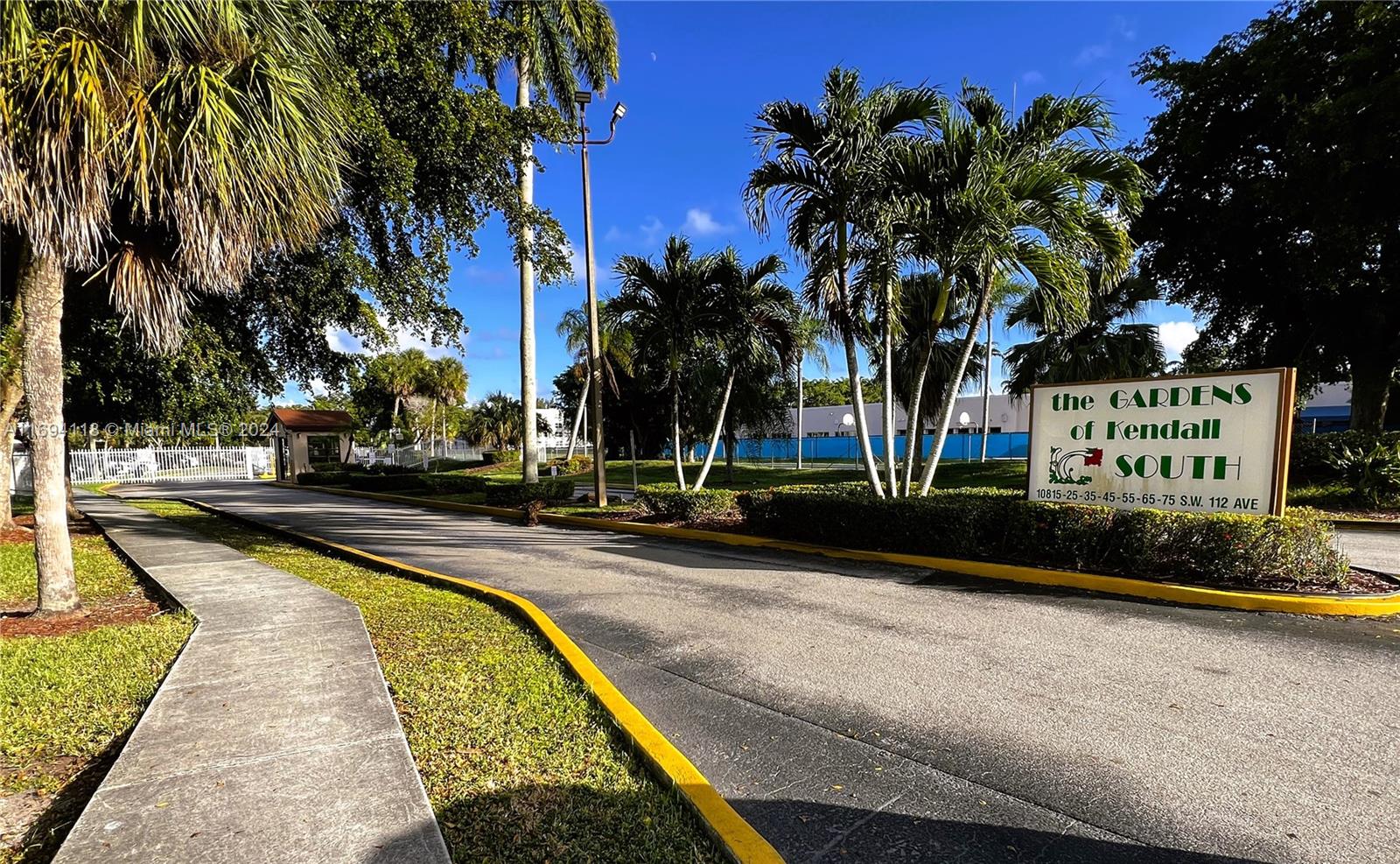 a view of swimming pool with palm trees