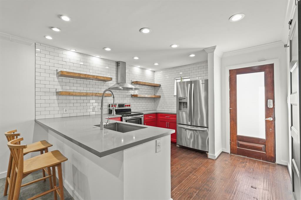 a kitchen that has a sink cabinets and wooden floor