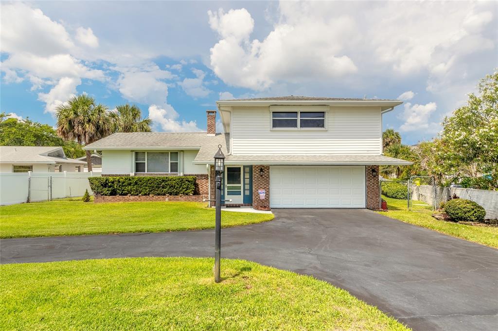 a front view of house with yard and entertaining space