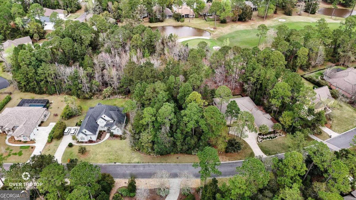 an aerial view of residential house with outdoor space and swimming pool