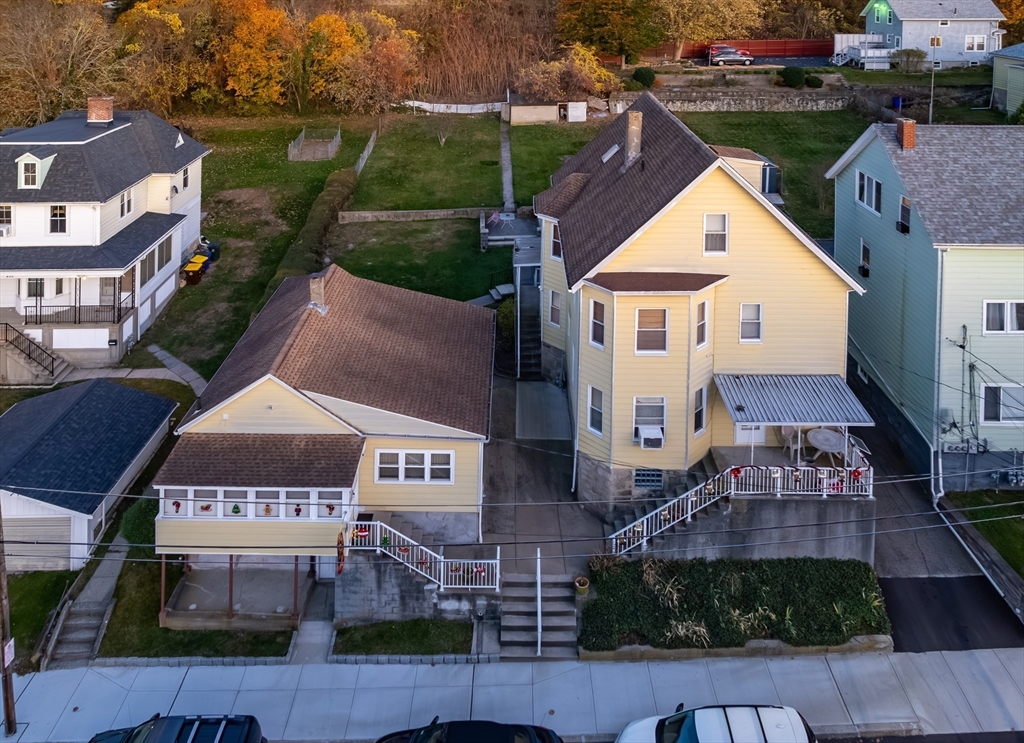 an aerial view of multiple houses with a yard