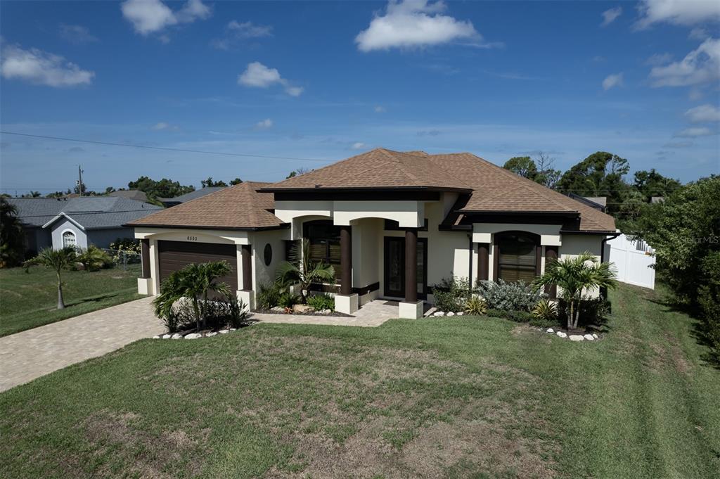 a front view of a house with garden