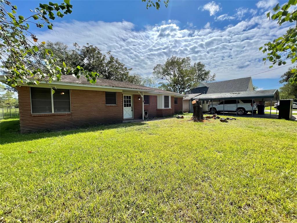 a view of a house with a yard and sitting area