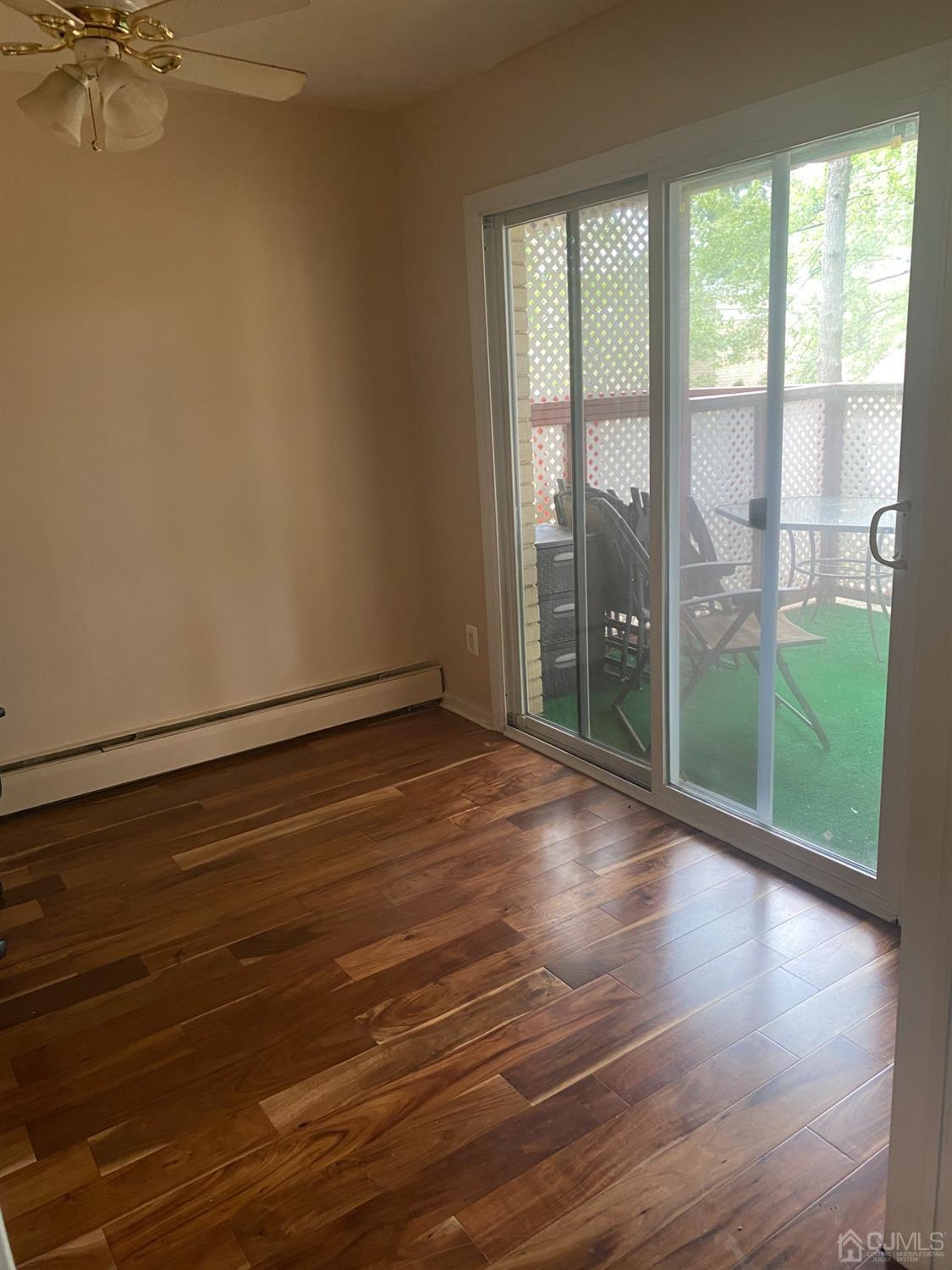 a view of a room with wooden floor and a window