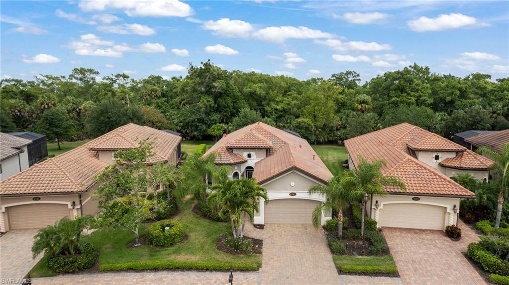 an aerial view of multiple houses with a yard