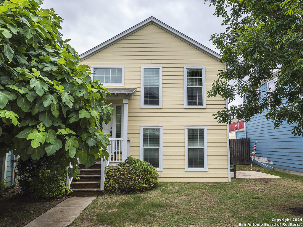 a view of a house with a yard and plants