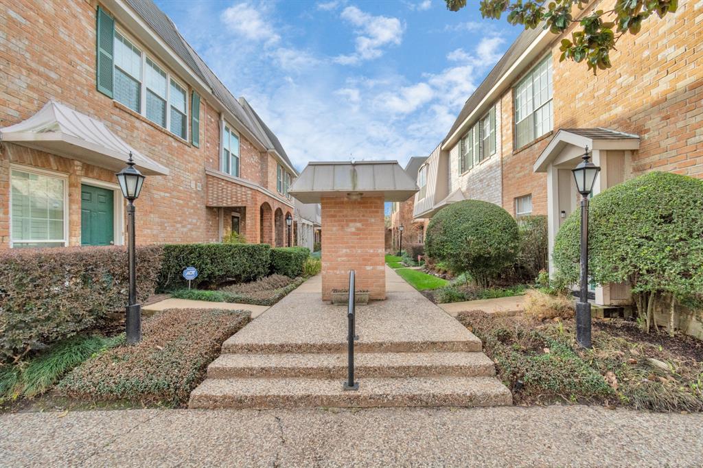 a view of a brick building next to a yard