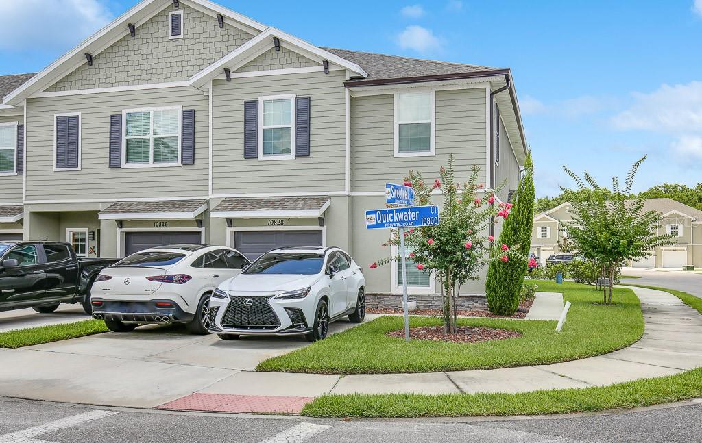 a couple of cars parked in front of a house