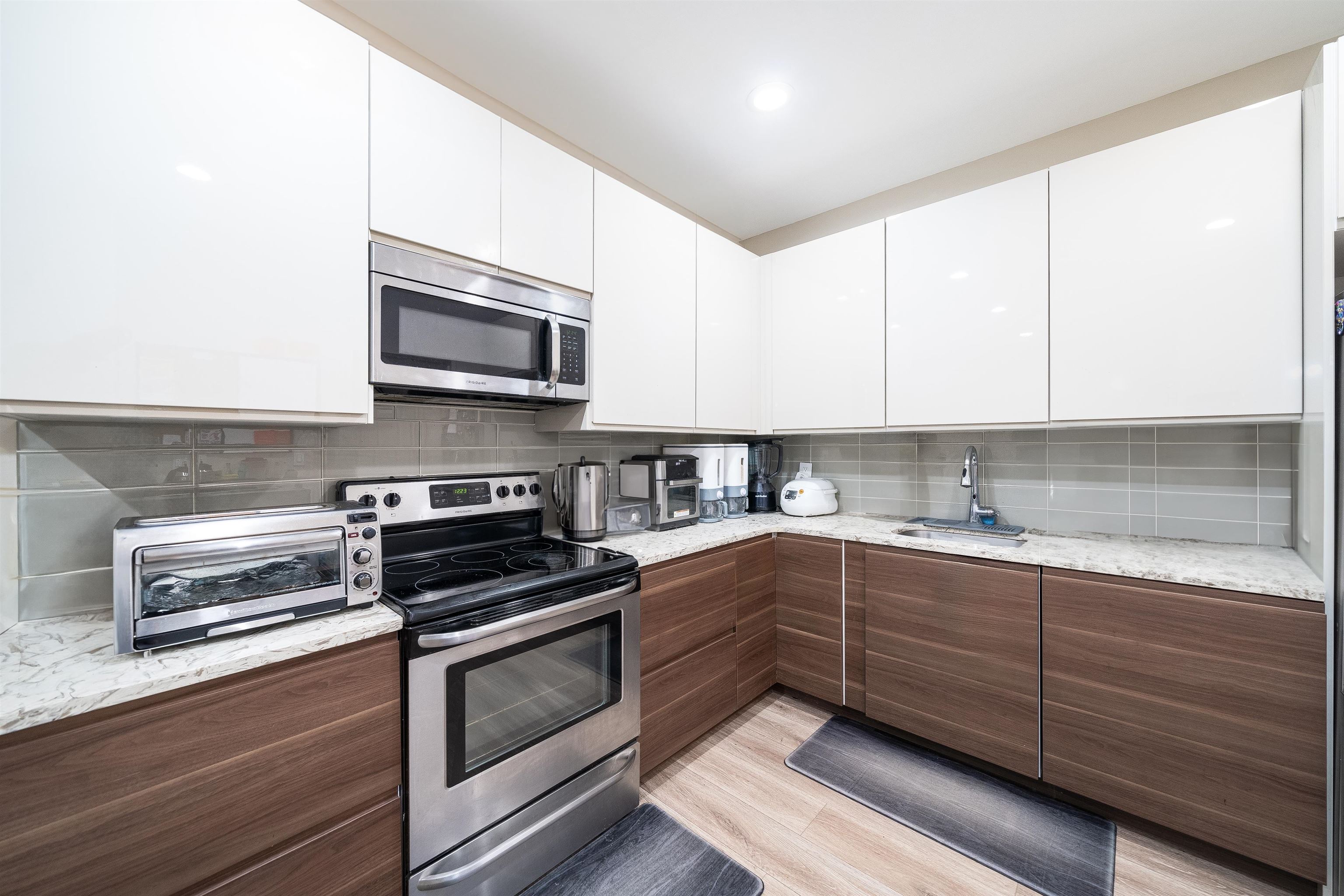 a kitchen with sink cabinets and stainless steel appliances