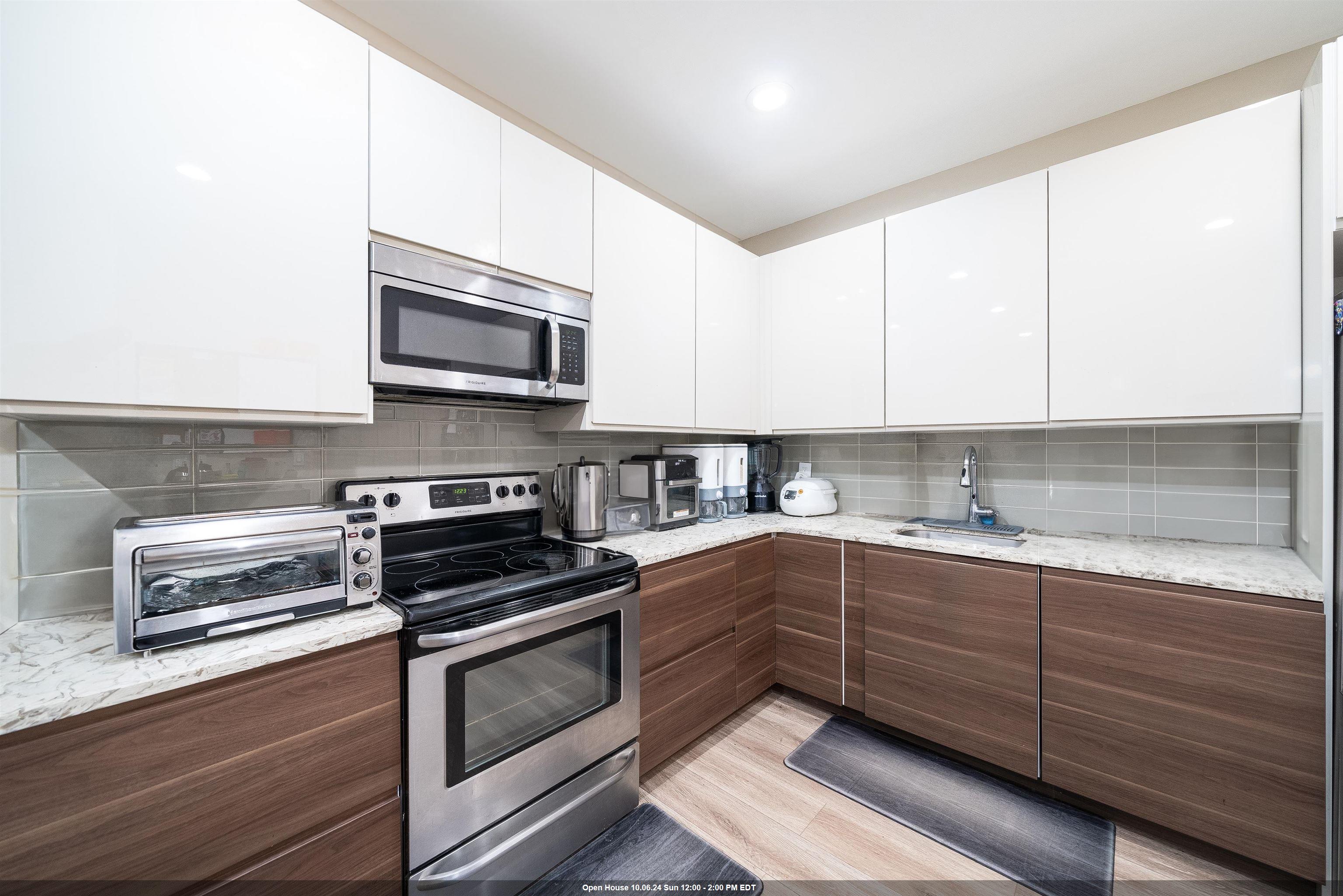 a kitchen with sink cabinets and stainless steel appliances