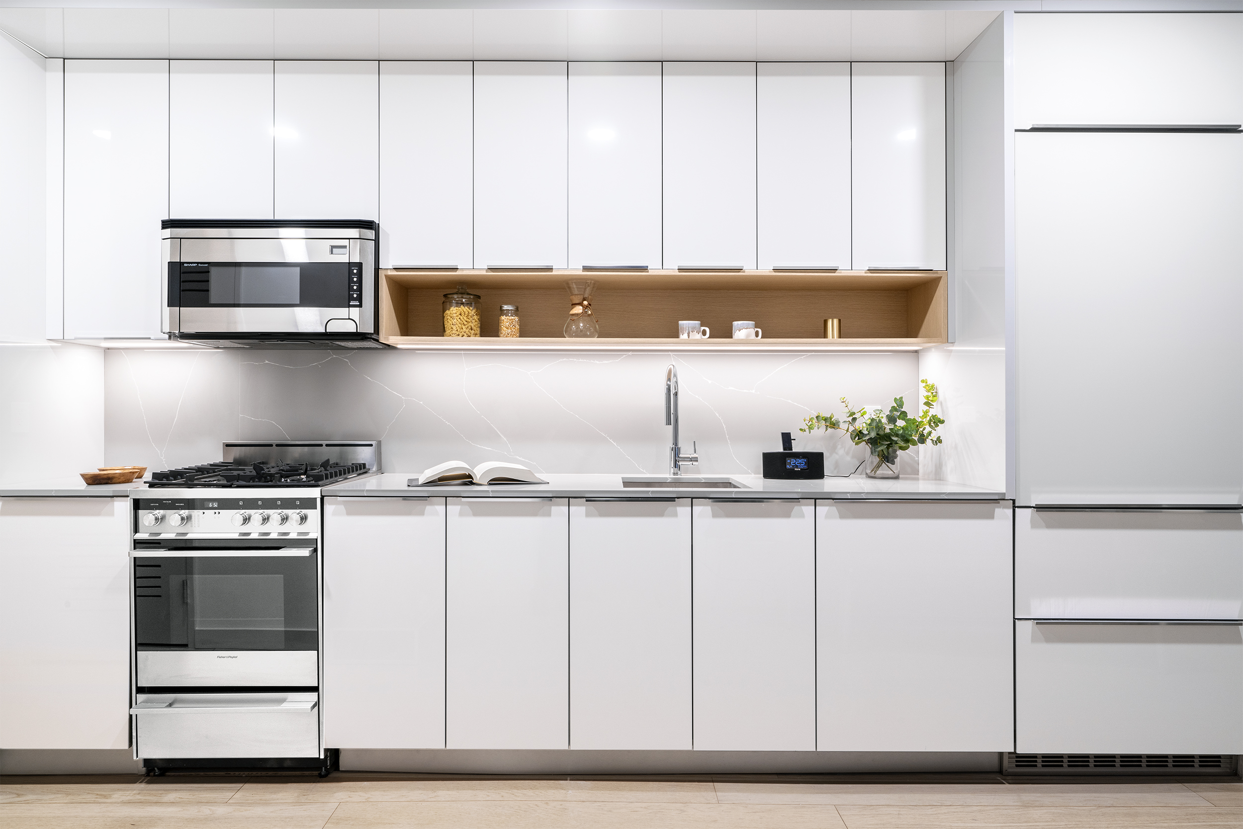 a kitchen with stainless steel appliances granite countertop white cabinets and a stove