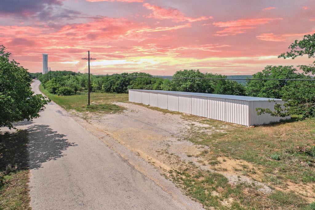 a view of a road with a big yard