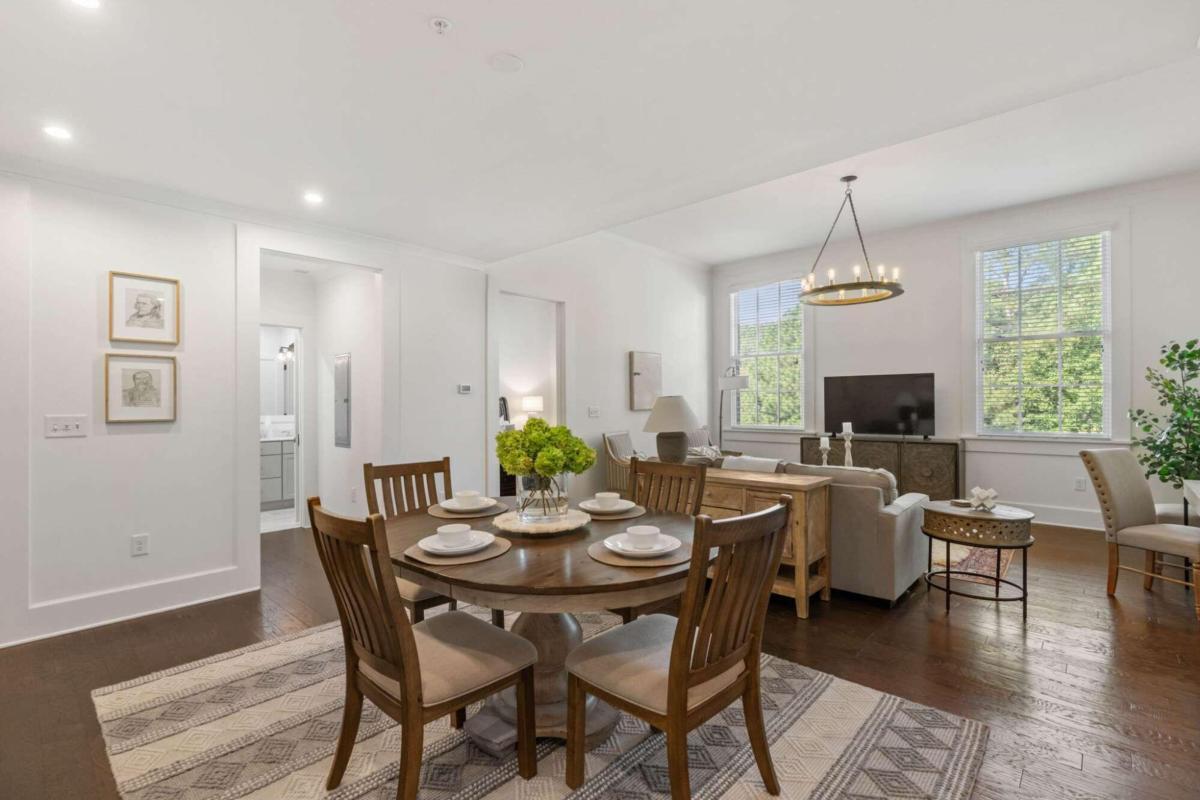 a view of a dining room with furniture window and wooden floor