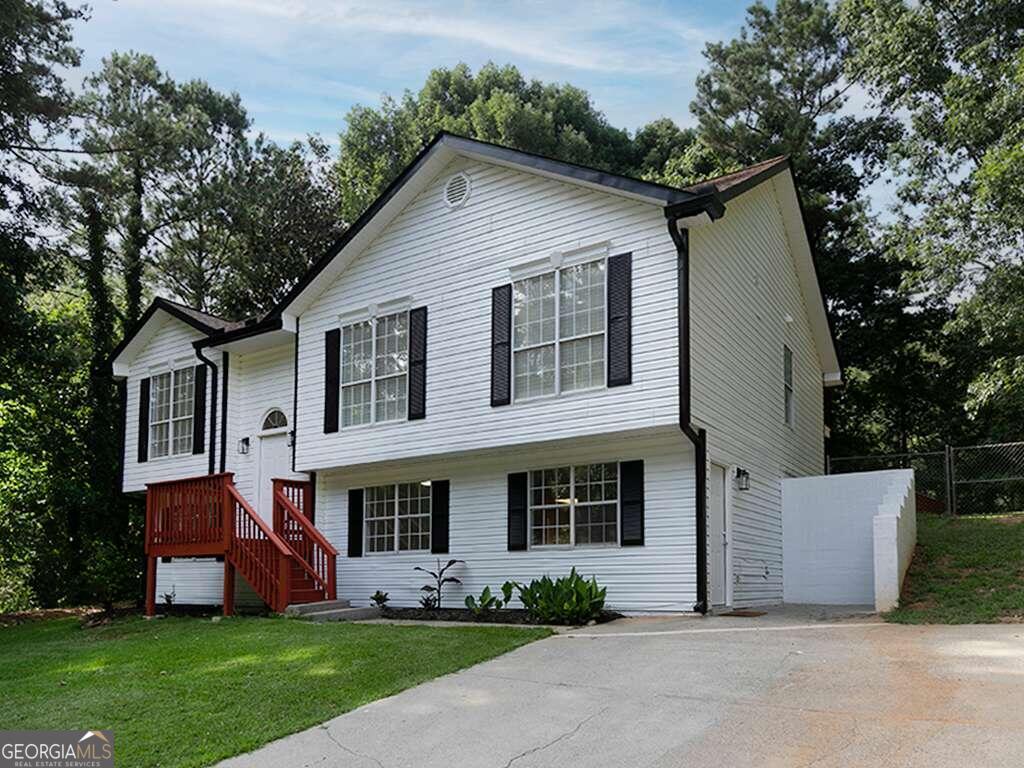 a front view of house with yard and green space