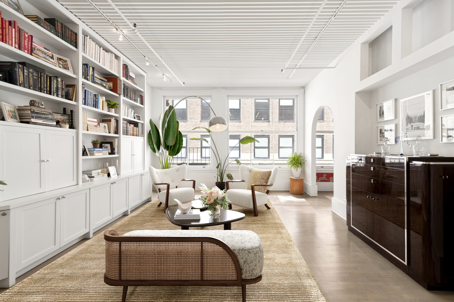 a living room with furniture cabinets and wooden floor