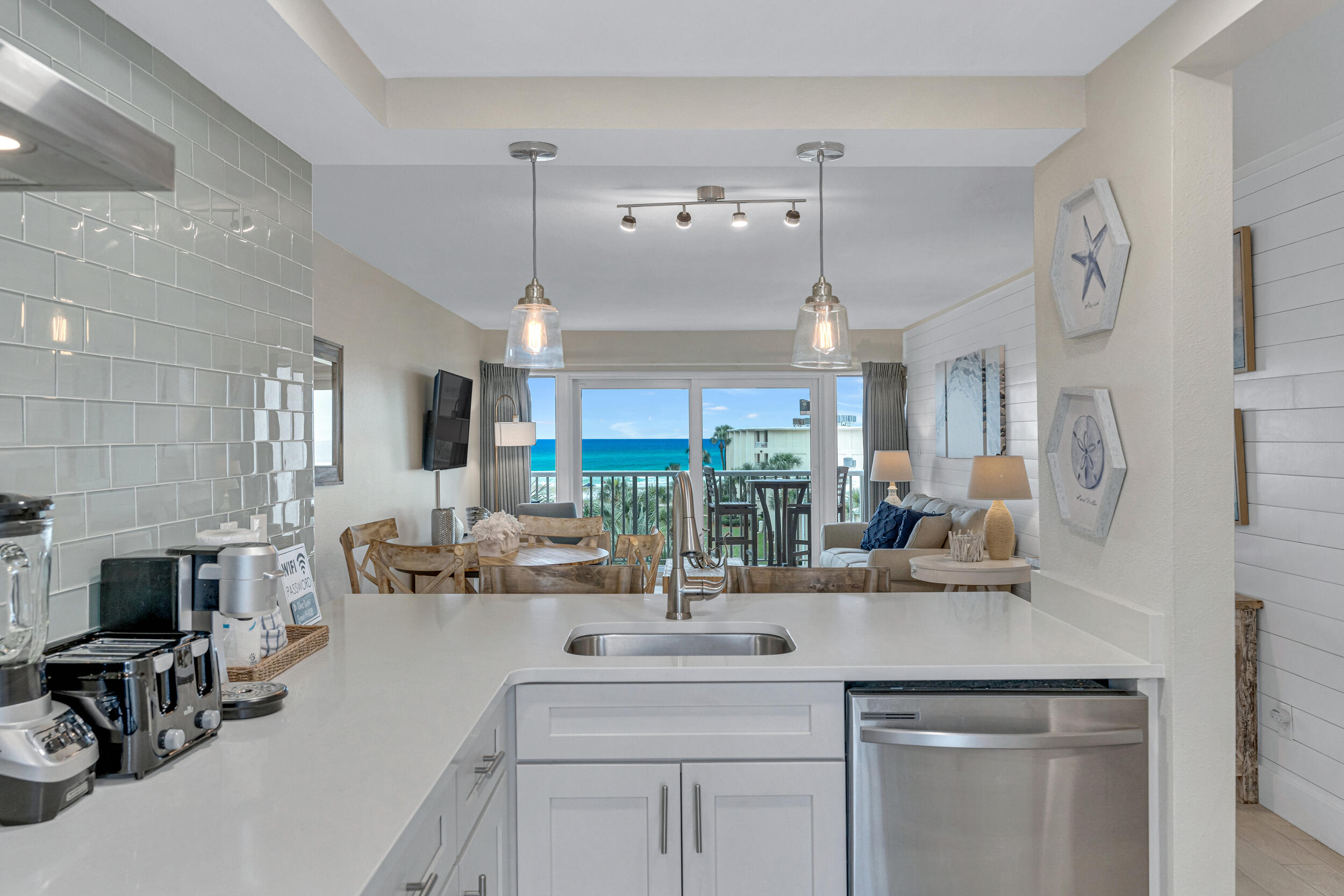 a kitchen with counter top space and living room