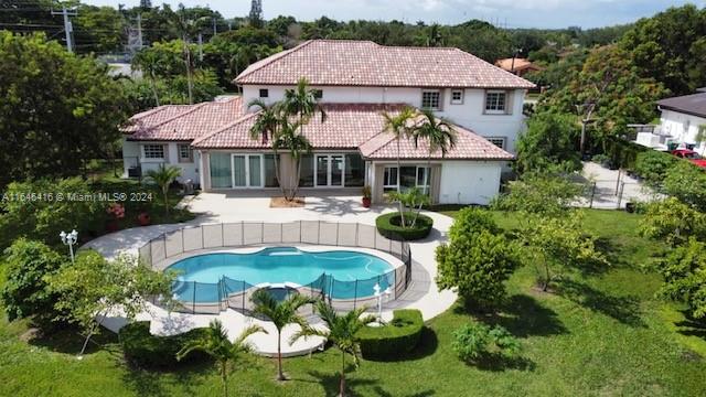 an aerial view of a house with swimming pool patio and outdoor seating