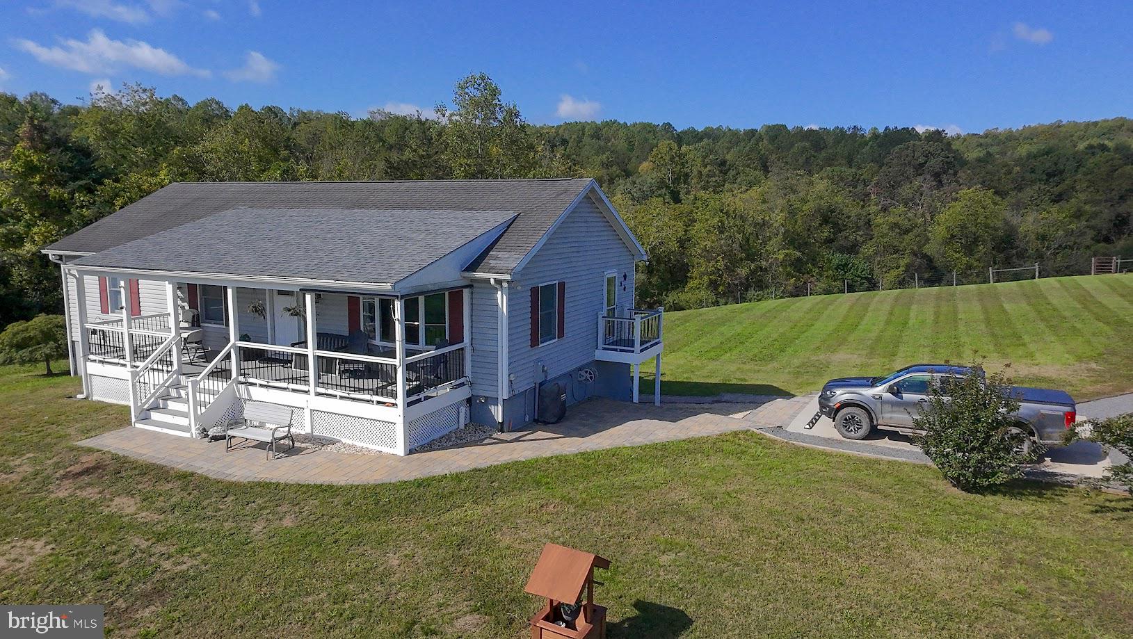 a view of a house with a yard patio and fire pit