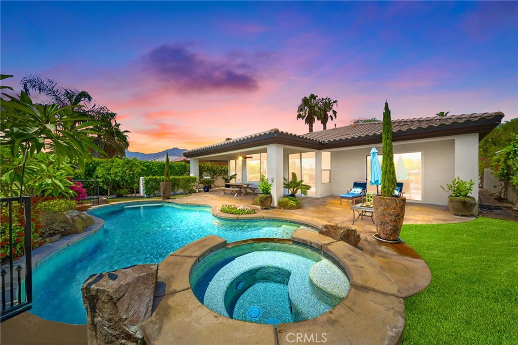 a view of a house with swimming pool yard and a patio