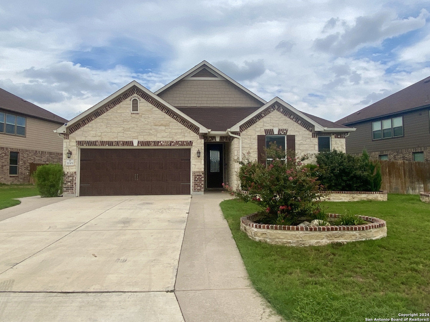 a front view of a house with a yard and garage