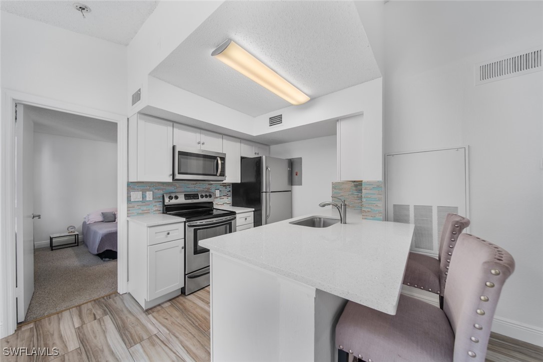 a kitchen with a table chairs a sink and a stove