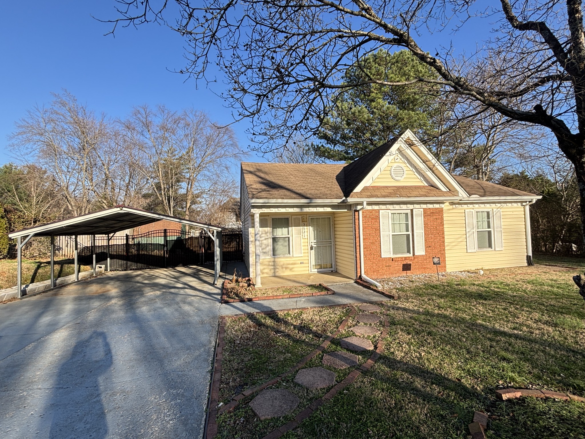 a view of a house with a yard and sitting area