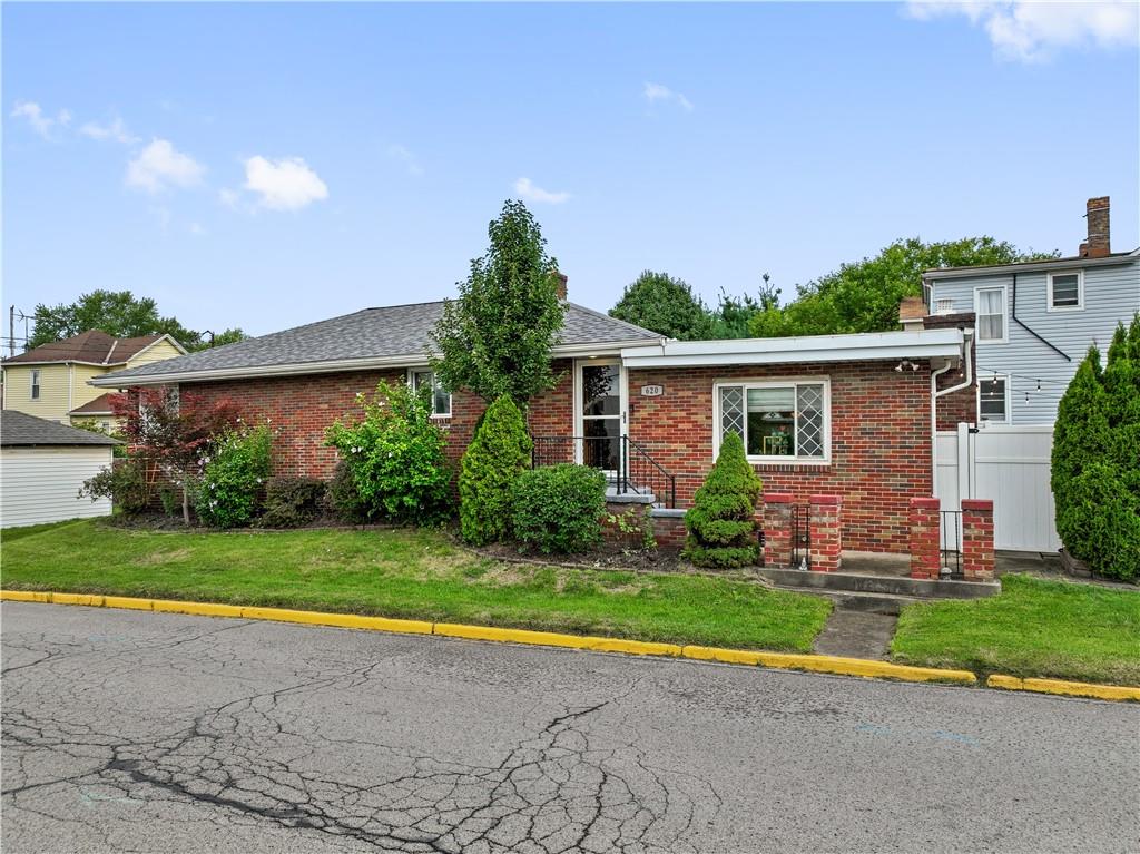 a view of a house with a yard and plants