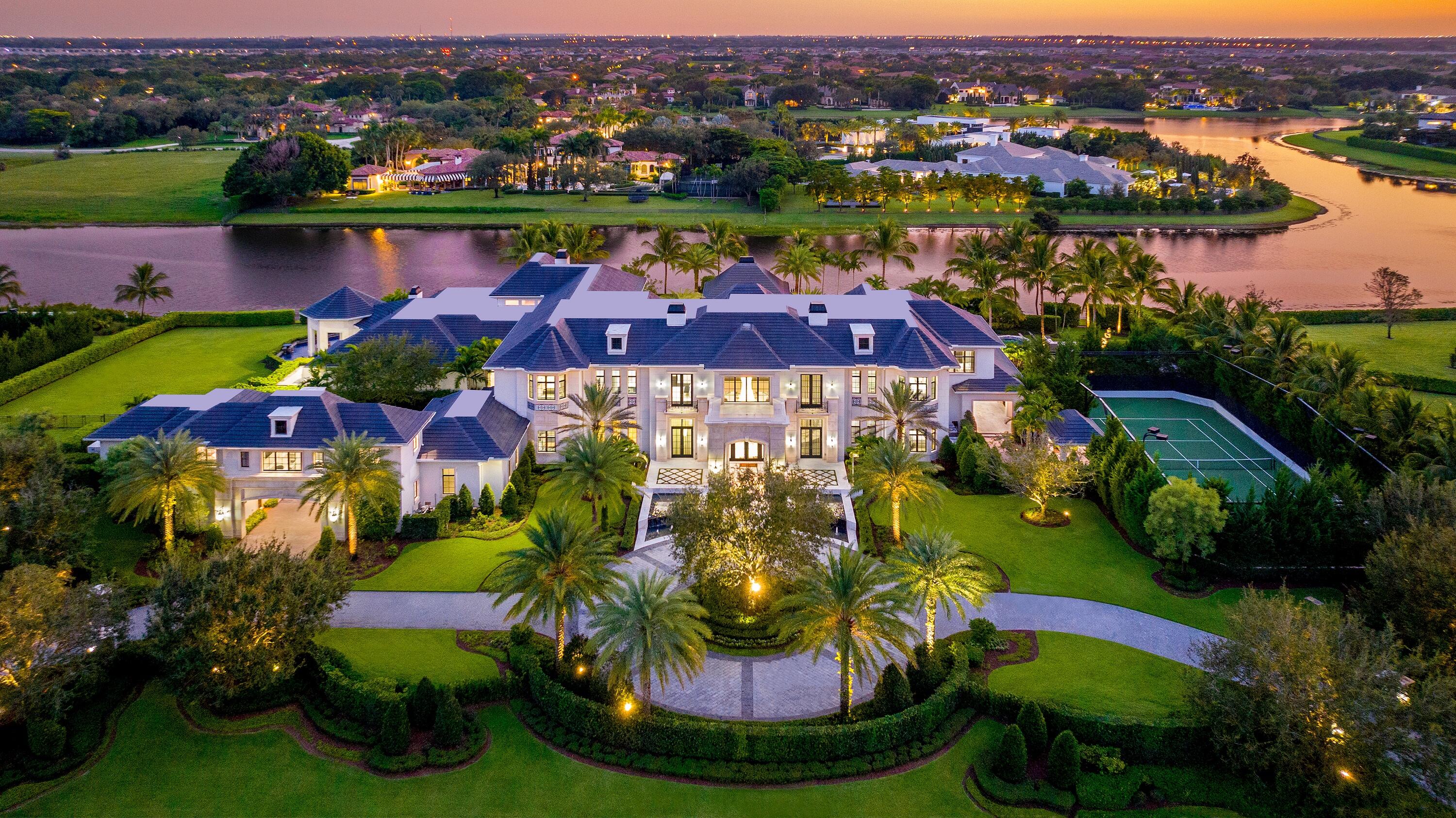 an aerial view of residential houses with outdoor space and lake view